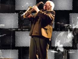 Photo of Brian Snowman Powers playing the Saxophone on stage.
