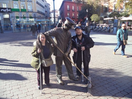 Tony, Tatiana with statue of a street sweeper, in Plaza de Jacinto Benavente.